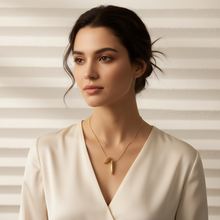 Woman wearing a Dual Drop Pendant against a neutral background