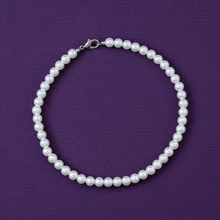 Pearl necklace on a purple background