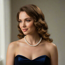Woman wearing a pearl necklace and blue dress in an elegant setting