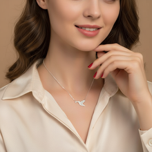 Woman wearing silver plated hummingbird pendant necklace with cream satin shirt